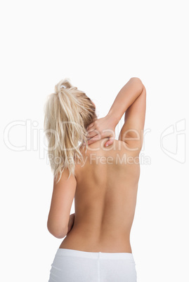 Rear view of topless woman with neck pain