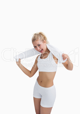 Excited woman in sportswear holding towel around neck