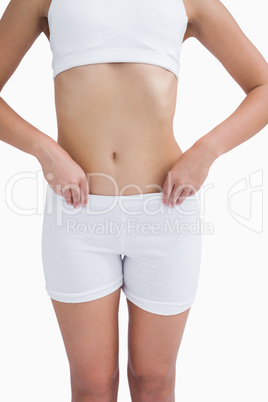 Midsection of fit woman in sportswear