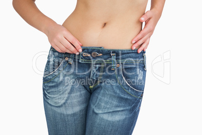 Midsection of slim woman in jeans