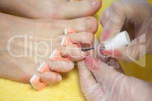 Close-up of woman applying nail varnish to toe nails