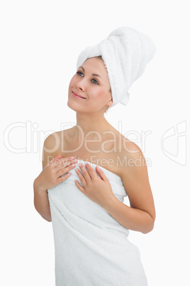 Happy young woman wrapped in towel