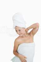 Happy young woman wrapped in towel