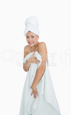 Portrait of embarrassed woman covering herself with towel