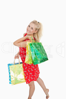 Portrait of cute young woman with shopping bags