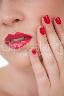 Woman red painted finger nails and red lips