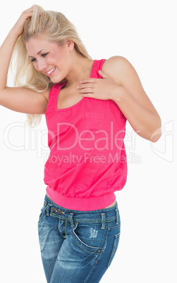 Happy casual woman with blonde hair dancing