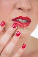 Woman red painted finger nails and red lips