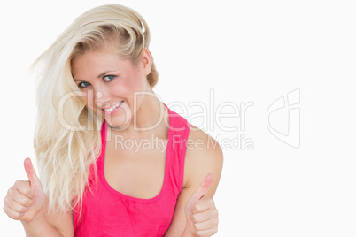 Casual young woman gesturing double thumbs up