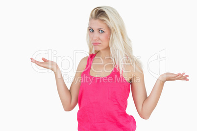 Beautiful young woman gesturing do not know sign