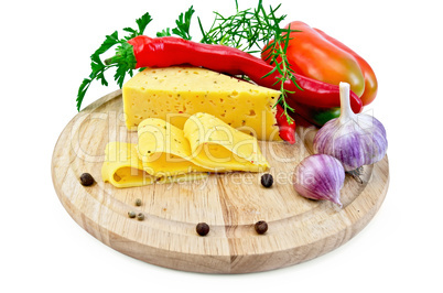 Cheese with pepper and herbs on a round board