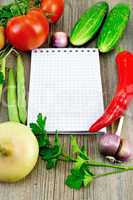 Notebook with vegetables and pepper