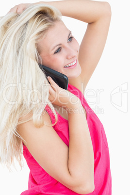 Side view of happy casual woman using cellphone