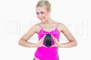 Portrait of casual young woman with new smartphone