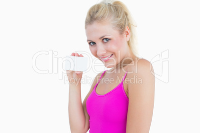 Portrait of beautiful woman holding blank card