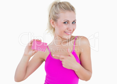 Portrait of beautiful woman pointing at blank card over
