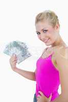 Young woman holding out fanned 100 euro banknotes