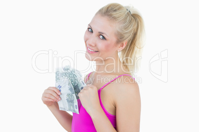 Portrait of happy woman with fanned euro banknotes