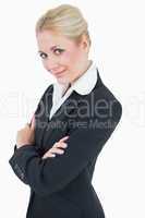 Portrait of confident young business woman standing with arms cr