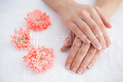 Flowers with french manicured fingers at spa center