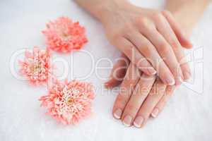 Flowers with french manicured fingers at spa center