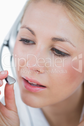 Close-up of young female executive wearing headset