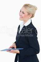 Smiling business woman with digital tablet looking away
