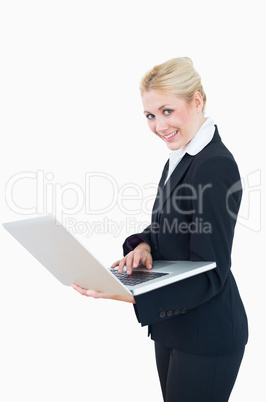 Portrait of happy businesswoman using laptop