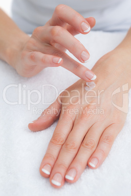 Woman applying cream on hand