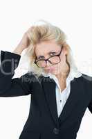 Portrait of frustrated business woman scratching head