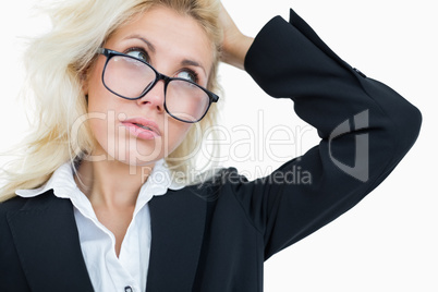 Close-up of frustrated business woman scratching head