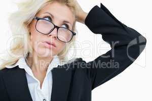 Close-up of frustrated business woman scratching head
