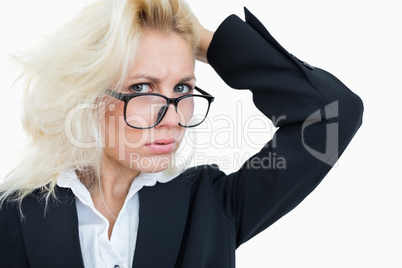Close-up portrait of frustrated business woman scratching head