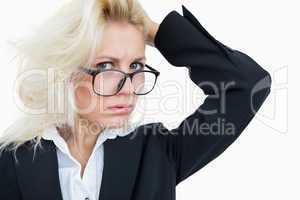 Close-up portrait of frustrated business woman scratching head