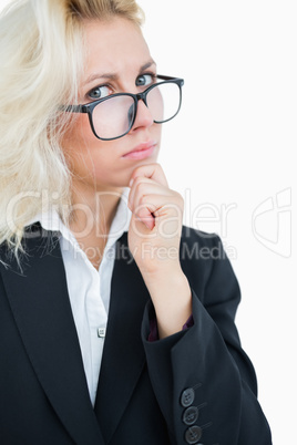 Portrait of thoughtful business woman with hand on chin