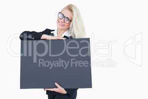 Portrait of happy young business woman holding blank board
