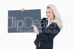 Portrait of business woman pointing at empty banner