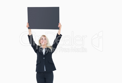 Young business woman holding up empty banner