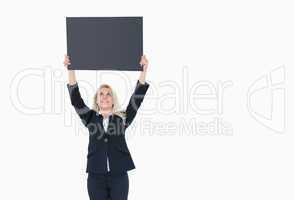 Young business woman holding up empty banner