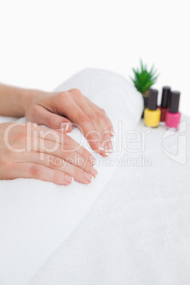 French manicured fingers and nail paint bottles