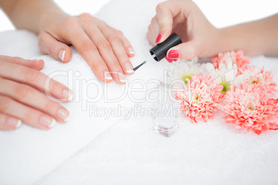 Woman applying nail varnish to finger nails