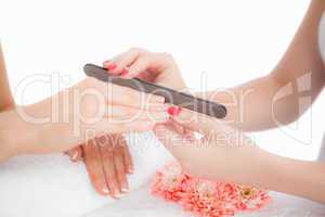 Close-up of woman filing fingernail