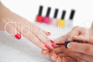 Woman applying nail varnish to finger nails