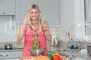 Portrait of woman preparing salad in the kitchen