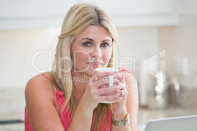 Close-up portrait of young woman with coffee cup
