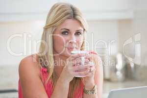 Close-up portrait of young woman with coffee cup