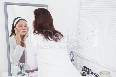 Young woman looking at mirror