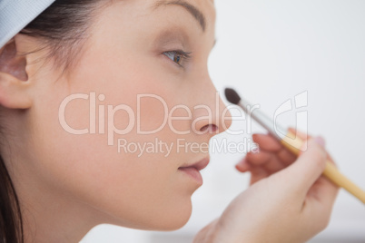 Close-up woman putting on make-up