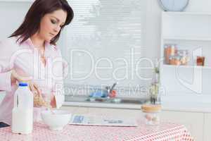 Woman pouring cereal in bowl