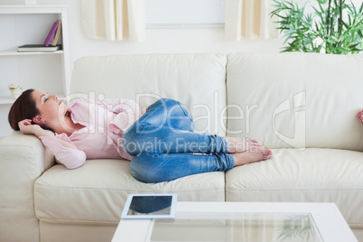 Casual woman resting on  couch at home